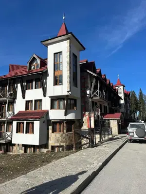 a building with a car parked in front of it at The Castle Bonko in Pamporovo