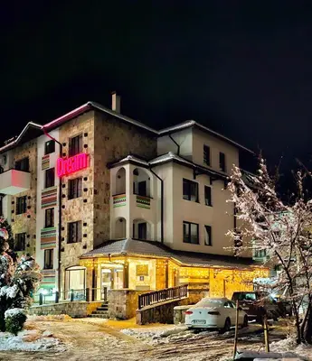 a building with a sign on the front of it at Suite in Dream Bansko in Bansko