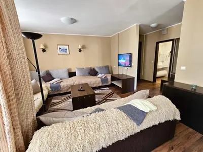 a living room with a couch and a table at Suite in Dream Bansko in Bansko