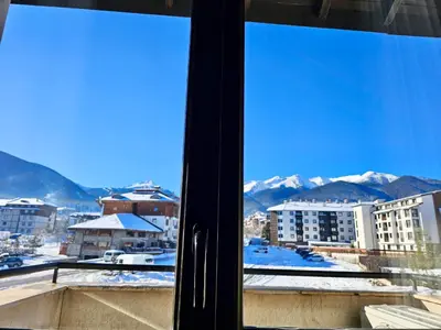 a view of a snowy mountain from a window at Suite in Dream Bansko in Bansko