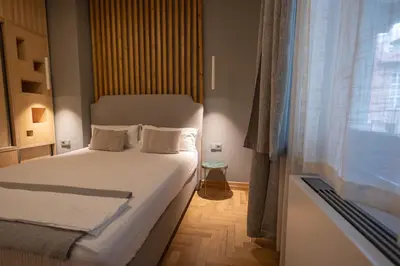 a small bedroom with a bed and a window at Luxury room 12-3 in Plovdiv