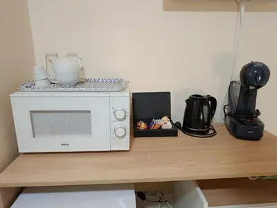 a microwave sitting on top of a wooden table at Студио Орфееви Скали in Pamporovo
