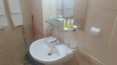 a bathroom with a white sink and a mirror at Апартамент за гости 4а26 Планинска Магия Grand Monastery Пампорово in Pamporovo