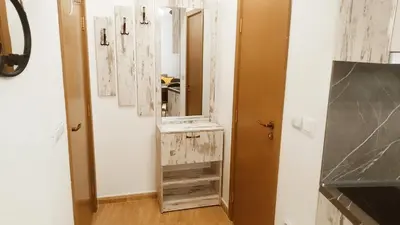 a bathroom with a vanity with a mirror and a sink at Апартамент за гости 4а26 Планинска Магия Grand Monastery Пампорово in Pamporovo