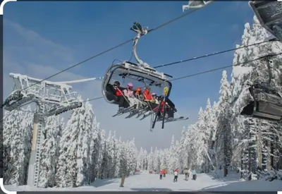 a group of people riding on a ski lift at Апартамент за гости 4а26 Планинска Магия Grand Monastery Пампорово in Pamporovo