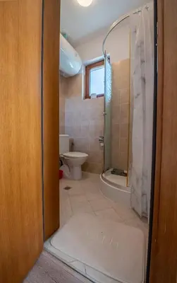 a bathroom with a shower and a toilet at Къща за гости В 12 и 5 in Dolna Banya