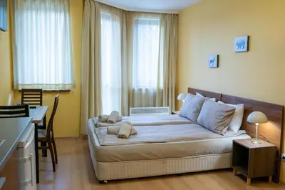 a bedroom with a bed with a teddy bear on it at Studio Villa Park 325 in Borovets