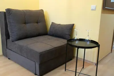 a couch and a table in a room at Studio Villa Park 325 in Borovets