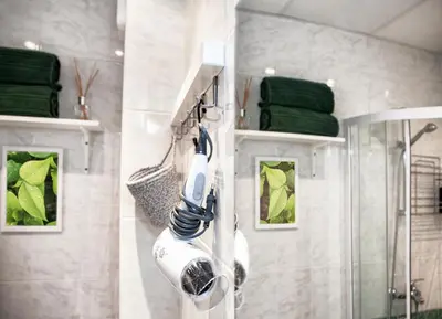 a bathroom with a shower with a blow dryer at New White Studio F next to Forest the Gondola in Bansko