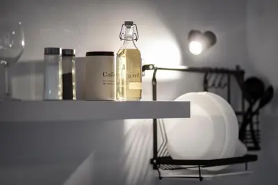 a bottle of wine on a shelf in a kitchen at New White Studio F next to Forest the Gondola in Bansko