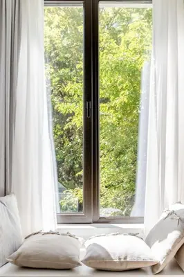 a window with two pillows sitting in front of it at Sophisticated Gem in the Heart of Sofia in Sofia