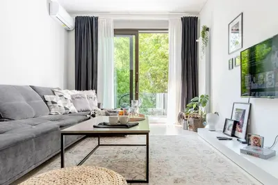 a living room with a couch and a coffee table at Sophisticated Gem in the Heart of Sofia in Sofia