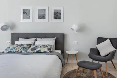 a bedroom with a bed and a chair at Sophisticated Gem in the Heart of Sofia in Sofia