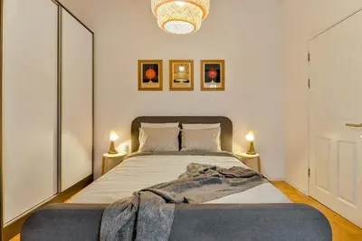 a bedroom with a bed with a blanket on it at Dreamy Sunset Loft in Sofia City Center in Sofia
