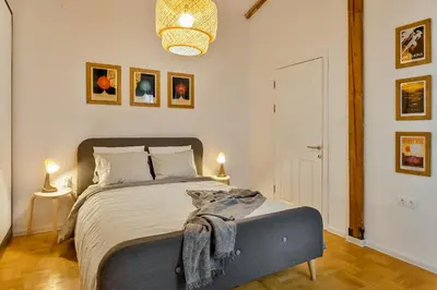 a bedroom with a large bed with two lamps and a bed sidx sidx sidx sidx at Dreamy Sunset Loft in Sofia City Center in Sofia