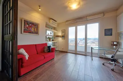 a living room with a red couch and a glass table at Sofia center best view by Flat Mаnager in Sofia
