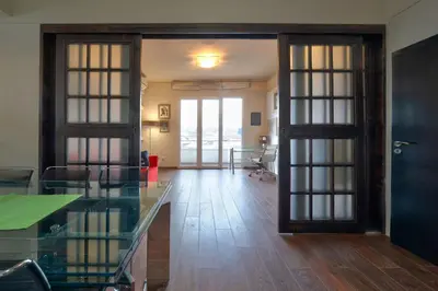 an open room with a glass door and a table at Sofia center best view by Flat Mаnager in Sofia