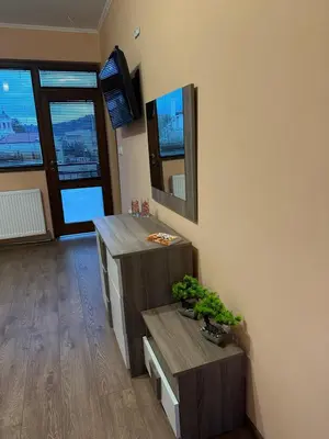 a room with a counter with a mirror and a table at Къща за гости Арнаудови in Kostandovo