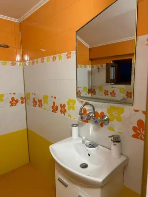 a bathroom with a sink and a mirror at Къща за гости Арнаудови in Kostandovo