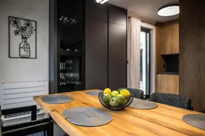a wooden table with a bowl of fruit on it at ARHEYA 8 apart/АРХЕЯ 8 апартамент за гости in Karlovo
