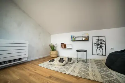 a living room with a couch and a table at ARHEYA 8 apart/АРХЕЯ 8 апартамент за гости in Karlovo