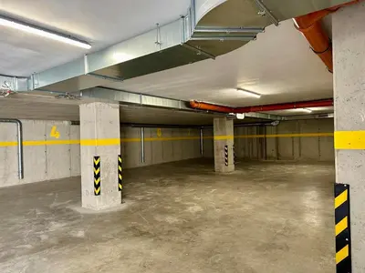an empty parking garage with columns in a parking lot at ARHEYA 8 apart/АРХЕЯ 8 апартамент за гости in Karlovo