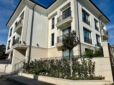 a large white building with balconies and flowers at ARHEYA 8 apart/АРХЕЯ 8 апартамент за гости in Karlovo