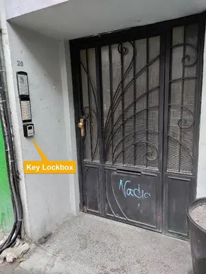 a black door with a key lookup sign on it at Elegant Getaway Near Iconic Eagles' Bridge in Sofia