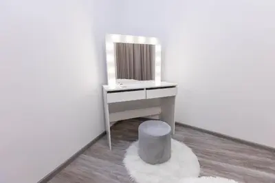 a bathroom with a vanity with a mirror and a stool at Bellalux in Sandanski