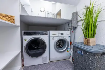 a laundry room with a washer and dryer in it at Bellalux in Sandanski