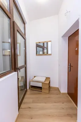 a hallway with a door and a bench in a room at Bellalux in Sandanski