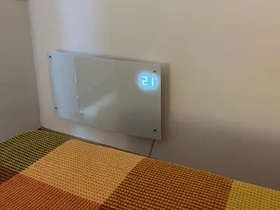 a clock on a wall next to a bed at Boro Hills in Borovets