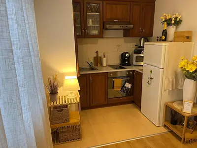 a small kitchen with a white refrigerator and a table at Boro Hills in Borovets