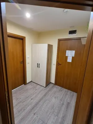 an empty room with two doors and a hallway at Forest Apartment/ Villa Park in Borovets