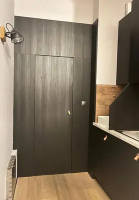 a black door in a room with a kitchen at Flower house 9 in Sofia