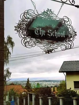 a sign for the school hanging in front of a house at Cappuccino apartment in Sofia