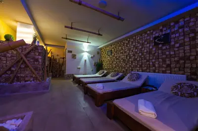 a room with four beds and a brick wall at Paradise SPA Hotel in Tsigov Chark