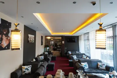 a living room with couches and a red carpet at Paradise SPA Hotel in Tsigov Chark