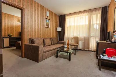 a living room with a couch and a table at Paradise SPA Hotel in Tsigov Chark