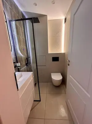 a white bathroom with a toilet and a shower at Chic Urban Retreat in Sofia