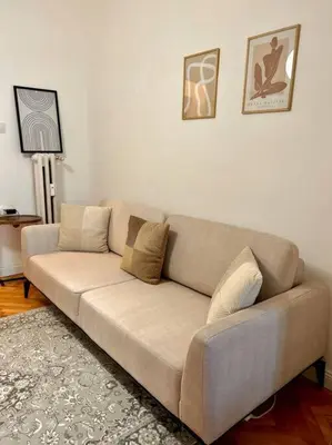 a living room with a couch in a room at Chic Urban Retreat in Sofia