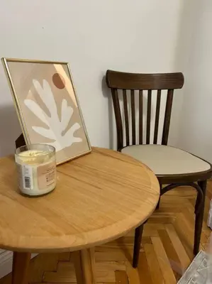 a table with a picture and a candle and a chair at Chic Urban Retreat in Sofia