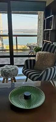 a living room with a green plate on a table at Rodopi Guest House in Tsigov Chark