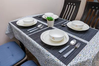 a table with plates and bowls and spoons on it at Topalov in Sandanski