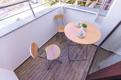 a small table and two chairs on a balcony at Topalov in Sandanski
