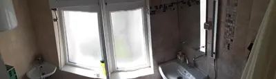 a bathroom with a toilet and a sink and a window at Studio V Plovdiv in Plovdiv