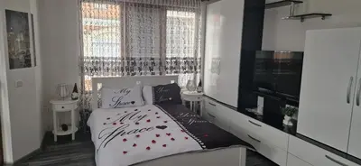 a bedroom with a bed with red hearts on it at Black and White Apartment in Karlovo