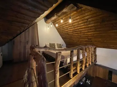 a wooden bed in a room with a wooden ceiling at CHALET ELEVEN in Dospat