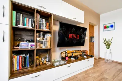 a living room with a book shelf with books at Doynov's Apartment in Sofia
