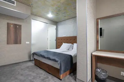 a small bedroom with a bed and a mirror at Hotel Boutique 5 - Free parking - Free breakfast - Free internet - EVSE in Sofia